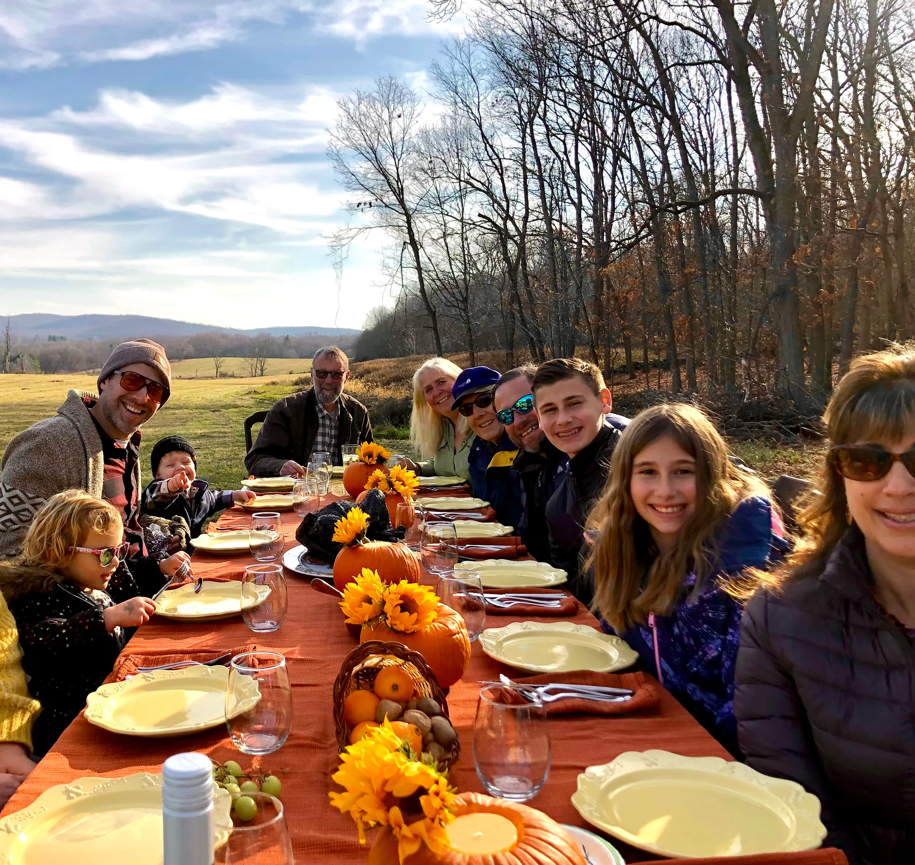 Family and friends gathered for an outdoor farm dinner at Gray Family Farm