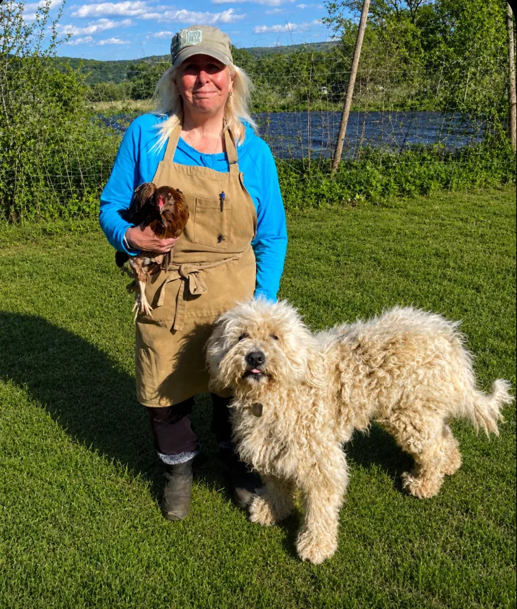 Shelley Gray with Zephyr, the farm dog Zephyr's Bites is named after, on pasture at Gray Family Farm